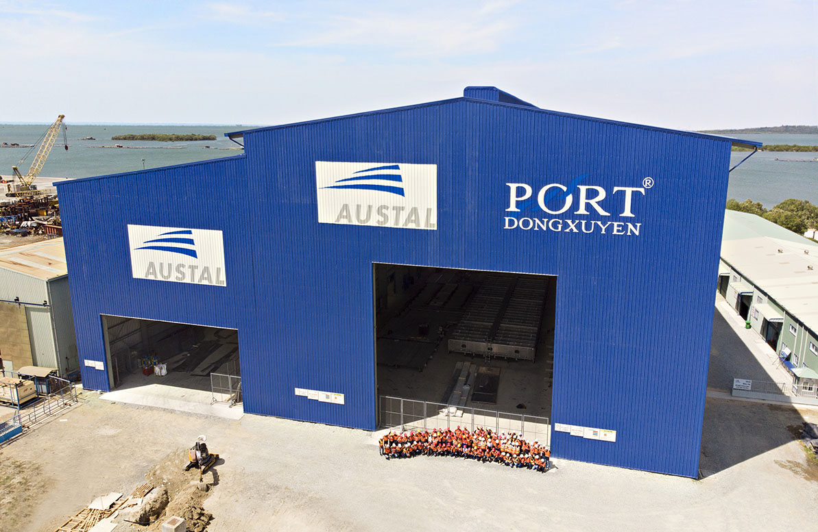 Image of Austal's Vietnam shipyard and a group of employees.