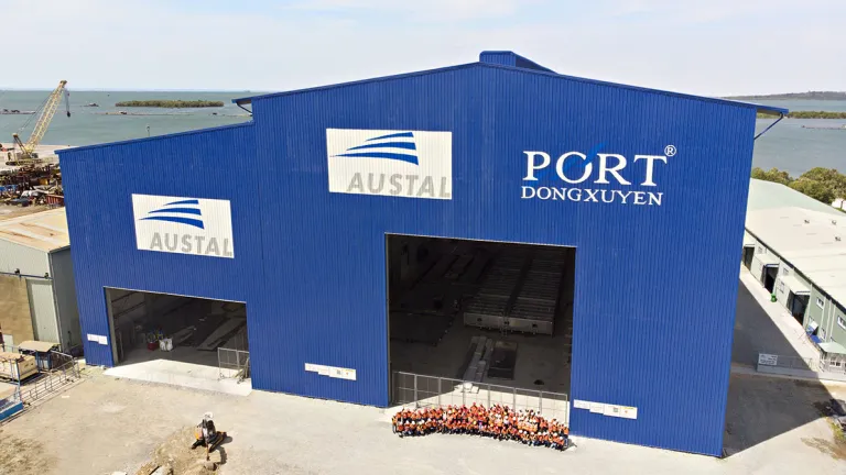 Image of Austal's Vietnam shipyard and a group of employees.